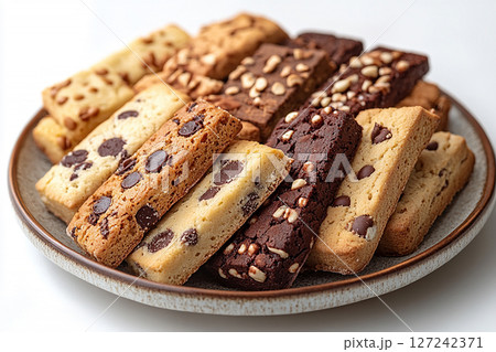 Variety of bakes and cookies in ceramic plate on a white background. 127242371