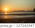 Golden Sunset Over Tranquil Beach and Mountains 127242947
