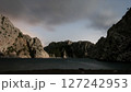 Serene Moonlit Cove Framed by Rugged Coastal Cliffs 127242953