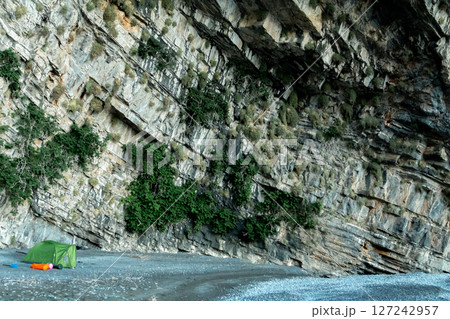 Wild Camping Beneath a Steep Rocky Cliff Face Wild Camping Beneath a Steep Rocky Cliff Face 127242957