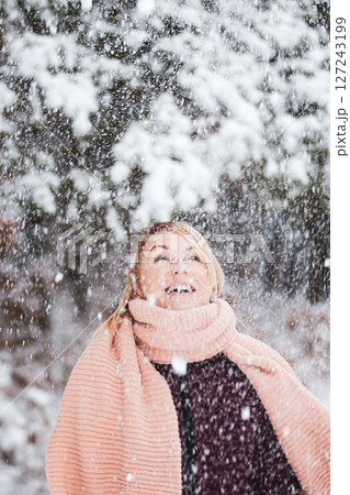 Blonde woman enjoy of snowing in the forest Blonde woman enjoy of snowing in the forest 127243199