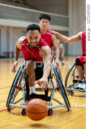 Exciting Wheelchair Basketball Game in an Indoor Gym With Enthusiastic Athletes Competing 127243505