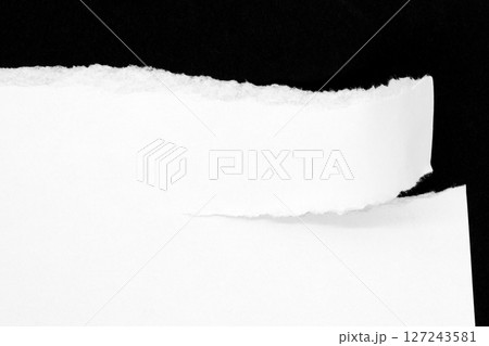 White ripped paper isolated on black background 127243581