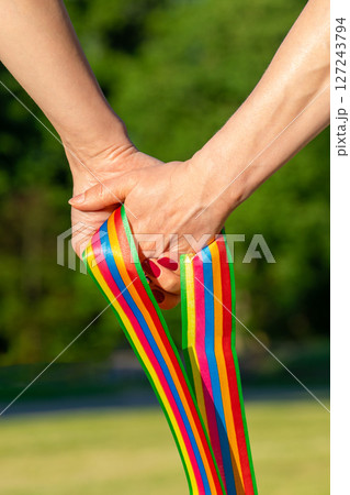 Women hold pride LGBT ribbon 127243794