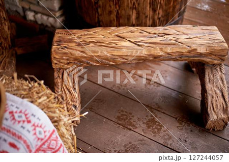Wedding decoration in the Slavic style. A wooden bench firmly hammered together in the technique of firing 127244057