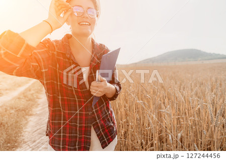 Woman wheat field. Agronomist, Woman farmer check golden ripe barley spikes in cultivated field. Closeup of female hand on plantation in agricultural crop management concept. Slow motion Woman wheat field. Agronomist, Woman farmer check golden ripe barley spikes in cultivated field. Closeup of female hand on plantation in agricultural crop management concept. Slow motion 127244456