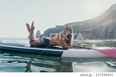 Woman Paddleboard Ocean Relaxing on Inflatable Paddleboard in Calm Water Woman Paddleboard Ocean Relaxing on Inflatable Paddleboard in Calm Water 127244481