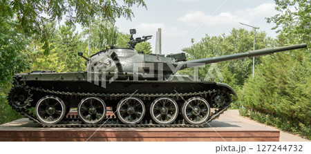 Soviet T-62 tank on a pedestal in a green park, a monument honoring military history Soviet T-62 tank on a pedestal in a green park, a monument honoring military history 127244732