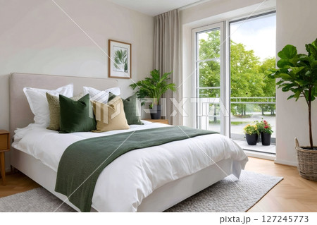 Modern bedroom with balcony overlooking green trees Modern bedroom with balcony overlooking green trees 127245773