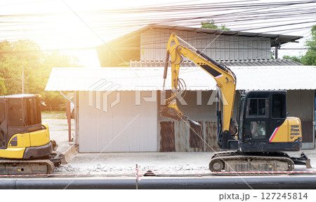 A mini excavator is working on a construction site. 127245814