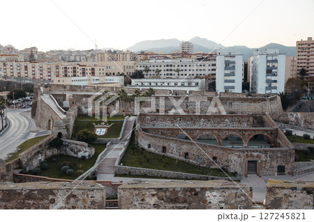 Historic Royal Walls of Ceuta with Urban Skyline at Sunset 127245821