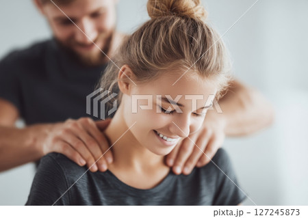 Chiropractor adjusts spine of athletic woman enhancing health through expert physiotherapy treatment. 127245873