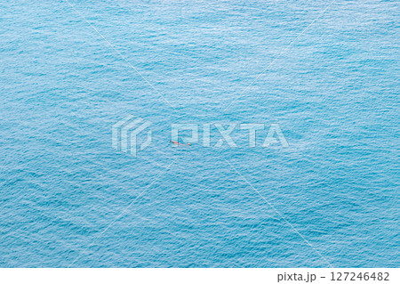 Aerial view of lonely swimmer swimming in the sea 127246482