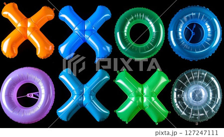 Colorful Inflatable Rings and X and O Game Pieces on Black Background 127247111