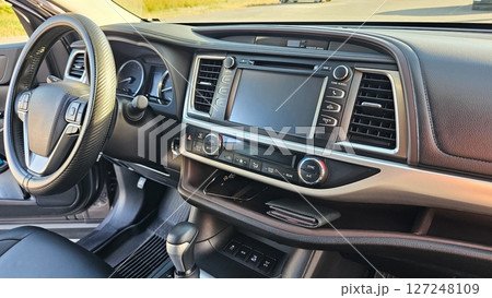 Car Interior View Dashboard, Steering Wheel and Console Offering Comfortable Ride Experience 127248109