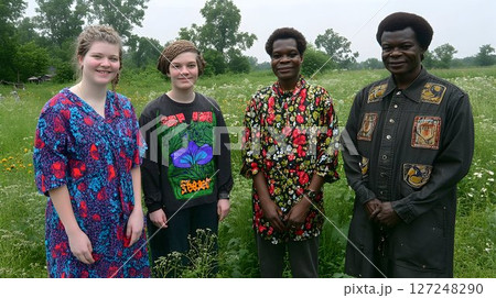 Diverse group of people standing together in a field 127248290