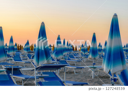Parasols and sunbeds in Rimini resort beach 127248539