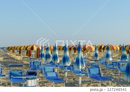 Parasols and sunbeds in Rimini resort beach 127248541