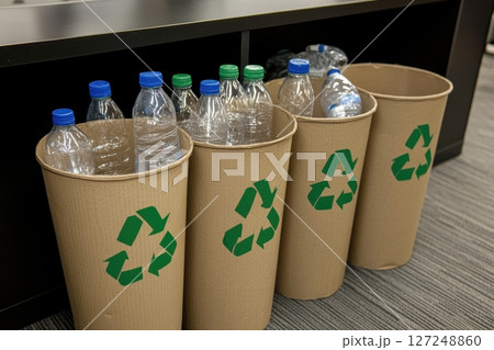 Recycle bins with recycling symbols filled with plastic bottles. Waste management. Glass in the bin for separating recycle materials from the garbage. Reducing waste, green concept. Recycling process 127248860