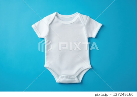 White Onesie. Baby clothes on blue pastel background. Fashion newborn clothes. Flat lay, top view. Baby kids clothing set. Smooth Infant bodysuit made from organic eco friendly cotton. Gender neutral White Onesie. Baby clothes on blue pastel background. Fashion newborn clothes. Flat lay, top view. Baby kids clothing set. Smooth Infant bodysuit made from organic eco friendly cotton. Gender neutral 127249160