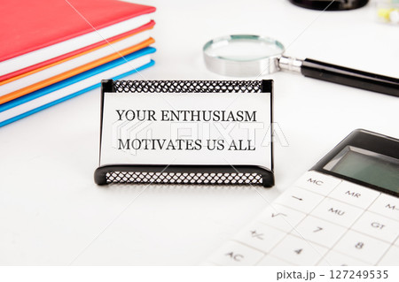 A motivational message sparks enthusiasm on a desk adorned with colorful notebooks, a calculator, and a magnifying glass, inspiring a vibrant study space A motivational message sparks enthusiasm on a desk adorned with colorful notebooks, a calculator, and a magnifying glass, inspiring a vibrant study space 127249535