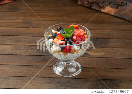 Portion of sweet layered desserd with berries 127249667