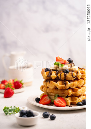 Tasty Belgian waffles with fresh berries Tasty Belgian waffles with fresh berries 127250066