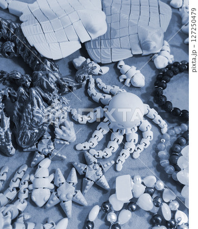 Art objects printed on a 3D printer. Various creative models created on a 3D printer from molten plastic. Concept 3D Printing. New modern 3D Printing additive technology. Blue color Art objects printed on a 3D printer. Various creative models created on a 3D printer from molten plastic. Concept 3D Printing. New modern 3D Printing additive technology. Blue color 127250479