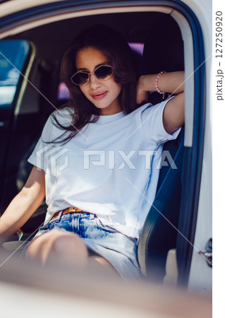Stylish Woman Sitting in Car Wearing Sunglasses Stylish Woman Sitting in Car Wearing Sunglasses 127250920