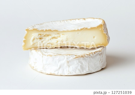 Fresh camembert cheese with sliced camembert isolated. Top view of camembert cheese piece on white background. Brie cheeses. Dairy products. Set of big round french cheeses with white mold. 127251039
