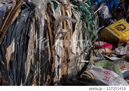 A landfill site showcases layers of compacted waste, highlighting the ongoing issues of pollution and the challenges in effective waste management A landfill site showcases layers of compacted waste, highlighting the ongoing issues of pollution and the challenges in effective waste management 127251418