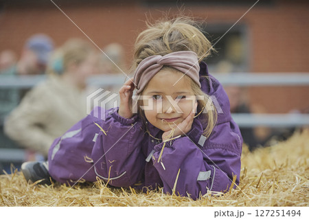 Charming child on a cows farm in Denmark Charming child on a cows farm in Denmark 127251494