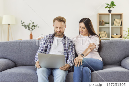 Family Couple Enjoying Online Entertainment Together On Couch At Home 127251505