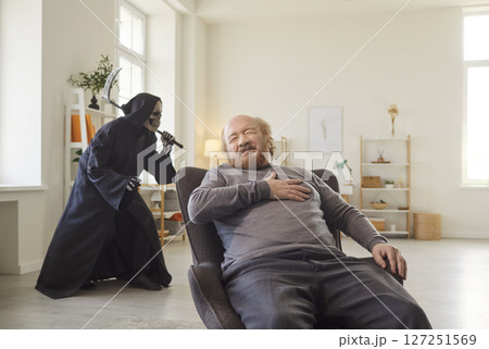 Senior man experiencing heart attack while grim reaper sneaking behind symbolizing imminent death. Senior man experiencing heart attack while grim reaper sneaking behind symbolizing imminent death. 127251569