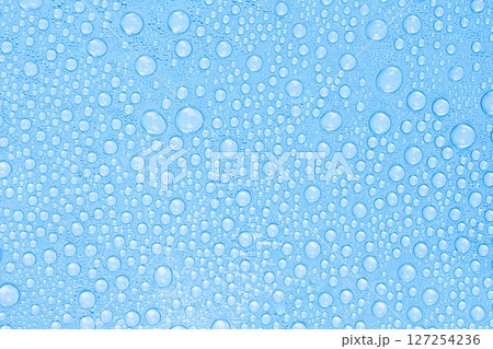 Water Drops on Blue Surface. Freshness and Clean Texture Background. Stock photo. 127254236