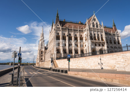 The Hungarian Parliament Building in Budapest, Hungary, features intricate neo Gothic details, spires, and symmetry, set near the Danube River under a clear sky. The Hungarian Parliament Building in Budapest, Hungary, features intricate neo Gothic details, spires, and symmetry, set near the Danube River under a clear sky. 127256414