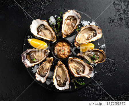 AI generated top view of fresh oysters grilled over charcoal, some shells open revealing plump juicy meat inside. Perfectly cooked with smoky aroma, seasoned with salt and black pepper, garnished. AI generated top view of fresh oysters grilled over charcoal, some shells open revealing plump juicy meat inside. Perfectly cooked with smoky aroma, seasoned with salt and black pepper, garnished. 127259272