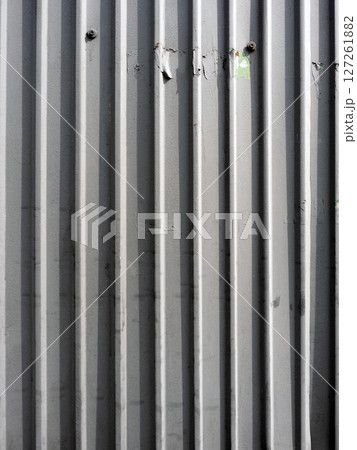 A textured gray metal surface with dents and scratches evokes sense of resilience and raw industrial beauty, showing weathering A textured gray metal surface with dents and scratches evokes sense of resilience and raw industrial beauty, showing weathering 127261882