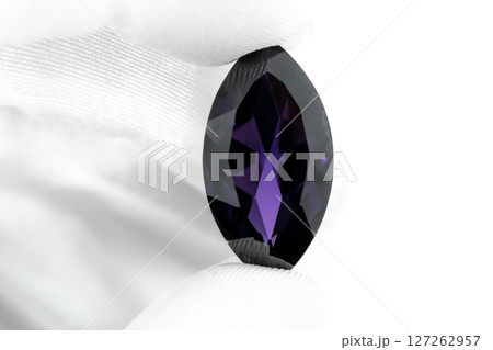 Hand with white gloves holding purple amethyst gemstone Hand with white gloves holding purple amethyst gemstone 127262957
