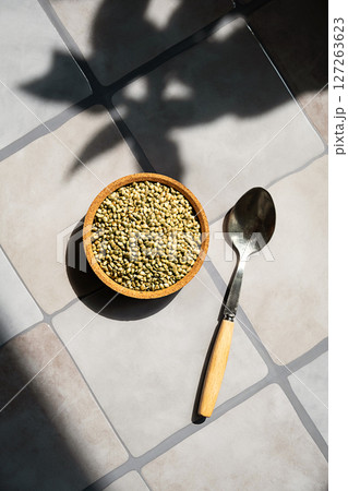 Bowl of Organic Hemp Seed on Tiled Surface. Healthy Plant Based Superfood Ingredient for Vegan Diet or Nutritional Concept. Bowl of Organic Hemp Seed on Tiled Surface. Healthy Plant Based Superfood Ingredient for Vegan Diet or Nutritional Concept. 127263623