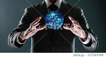 businessman holding a sphere with a globe in his hands. businessman holding a sphere with a globe in his hands. 127263769