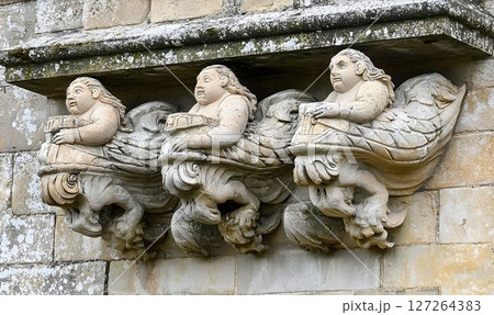 Antique Stone Carvings, Winged Figures Adorning a Building's Facade 127264383