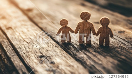 Representing family bonds and values through wooden figurines on rustic wood 127264953