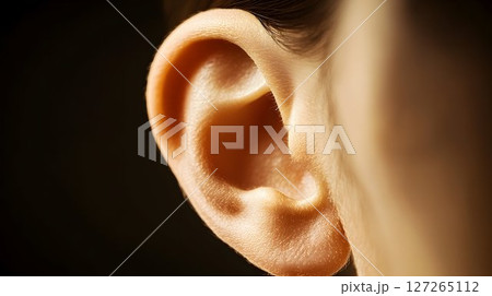 Macro close-up of a human ear showcasing intricate details and textures 127265112