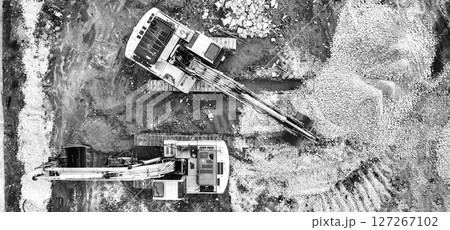 stopped excavators at a construction site 127267102