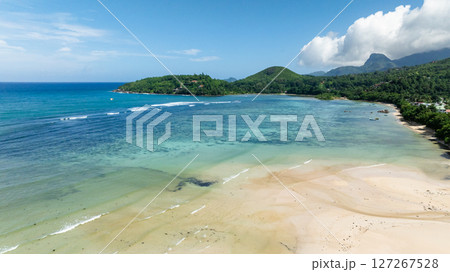 Golden sandy beach, gentle waves, and tropical vegetation. Seychelles, Mahe. Golden sandy beach, gentle waves, and tropical vegetation. Seychelles, Mahe. 127267528