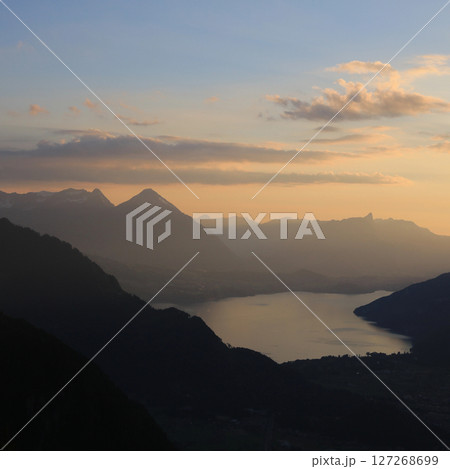 Golden evening sky over Lake Thun and Mt Niesen, Switzerland. Golden evening sky over Lake Thun and Mt Niesen, Switzerland. 127268699