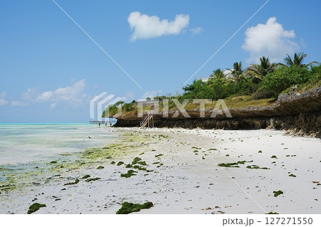 Scenic washed out rocks at jambiani beach on Indian Ocean in African Zanzibar island in Tanzania 127271550