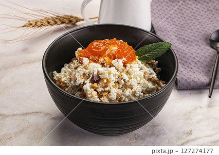 Curd with granola and orange jam 127274177
