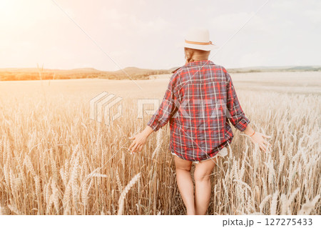 Woman wheat field. Agronomist, Woman farmer check golden ripe barley spikes in cultivated field. Closeup of female hand on plantation in agricultural crop management concept. Slow motion Woman wheat field. Agronomist, Woman farmer check golden ripe barley spikes in cultivated field. Closeup of female hand on plantation in agricultural crop management concept. Slow motion 127275433